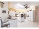 A spacious kitchen featuring white cabinets, stainless steel appliances, and a center island at 832 Carnoustie Dr, Venice, FL 34293