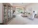 Bright living room featuring plush carpet, stylish furnishings, and expansive glass doors at 832 Carnoustie Dr, Venice, FL 34293