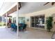 Outdoor patio with seating, dining area and potted plants, perfect for entertaining or relaxing outdoors at 832 Carnoustie Dr, Venice, FL 34293