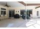 Covered patio area, ideal for outdoor dining and relaxing, with ceiling fan, bar and access to the house at 832 Carnoustie Dr, Venice, FL 34293