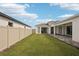 Well-maintained lawn of a modern home with a fenced-in yard and a paved patio for outdoor relaxation at 8405 Golden Beach Ct, Parrish, FL 34219