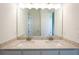Bright bathroom featuring a double vanity, granite countertop, and modern fixtures at 8405 Golden Beach Ct, Parrish, FL 34219
