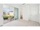Spacious bedroom with carpet, a view of the outdoor patio, and an ensuite bathroom at 8405 Golden Beach Ct, Parrish, FL 34219