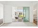 Bright bedroom with a patio view and a glimpse into the ensuite bathroom at 8405 Golden Beach Ct, Parrish, FL 34219