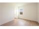 Light-filled bedroom has hardwood floors, a window with a view, and an ensuite bathroom at 8405 Golden Beach Ct, Parrish, FL 34219