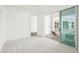 Open bedroom with carpet, sliding glass doors to the outdoor patio and an ensuite bathroom at 8405 Golden Beach Ct, Parrish, FL 34219