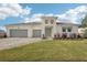Beautifully landscaped modern home with a three-car garage and a stylish paver driveway at 8405 Golden Beach Ct, Parrish, FL 34219