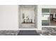 Warm foyer space furnished with white chairs and a modern rug, bathed in natural light at 8405 Golden Beach Ct, Parrish, FL 34219