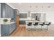 Modern kitchen featuring sleek gray cabinets, stainless steel appliances, and a spacious center island at 8405 Golden Beach Ct, Parrish, FL 34219