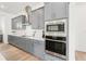 Well-equipped kitchen with stainless steel appliances, gray cabinetry and a contemporary design at 8405 Golden Beach Ct, Parrish, FL 34219