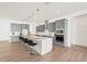 A modern kitchen features gray cabinets, a center island with bar seating, and stainless steel appliances at 8405 Golden Beach Ct, Parrish, FL 34219