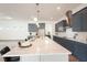 A modern kitchen with gray cabinets, an extra-long island with seating, and stainless steel appliances at 8405 Golden Beach Ct, Parrish, FL 34219