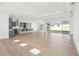 Spacious living area features wood flooring, open floor plan and sliding glass doors to the patio at 8405 Golden Beach Ct, Parrish, FL 34219