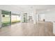 A bright living room with wood floors and sliding glass doors leading to the backyard at 8405 Golden Beach Ct, Parrish, FL 34219