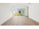 A modern living room with wood floors and sliding glass doors leading to the backyard at 8405 Golden Beach Ct, Parrish, FL 34219