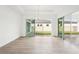 Bright living room with wood floors and sliding glass doors providing backyard views at 8405 Golden Beach Ct, Parrish, FL 34219