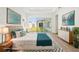 Staged main bedroom showcasing decor and furniture with a sliding glass door leading to the backyard at 8405 Golden Beach Ct, Parrish, FL 34219
