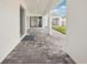 Covered patio with modern brick and a view of the green backyard at 8405 Golden Beach Ct, Parrish, FL 34219