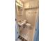 Small bathroom with a white toilet, sink, overhead storage and tile flooring at 8731 Peggy Ave, Sarasota, FL 34231