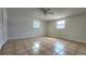 Well-lit bedroom with neutral walls, tiled flooring, built in wardrobe and two windows at 8731 Peggy Ave, Sarasota, FL 34231