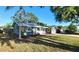 Charming single-story home featuring a well-manicured front yard and an attached garage with tropical landscaping at 8731 Peggy Ave, Sarasota, FL 34231