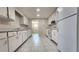 Traditional kitchen with white cabinetry, appliances, tile backsplash, and tiled floors at 8731 Peggy Ave, Sarasota, FL 34231