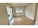Bright living room area with tile flooring and sliding glass doors leading to screened patio at 8731 Peggy Ave, Sarasota, FL 34231