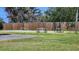 Community tennis court and picnic tables surrounded by lush greenery and a wooden fence at 8731 Peggy Ave, Sarasota, FL 34231