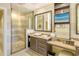 Bathroom with a vanity, glass-enclosed shower, and a wall-mounted television at 915 Seaside Dr # 606 Weeks 6-7, Sarasota, FL 34242