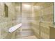 Walk-in shower featuring intricate tile work, a built-in bench, and modern fixtures at 915 Seaside Dr # 606 Weeks 6-7, Sarasota, FL 34242