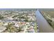 Expansive aerial shot of a waterfront community highlighting canals, docks, and varied rooftops at 10616 Ayear Rd, Port Charlotte, FL 33981