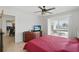 Main bedroom featuring a patio access, a ceiling fan and wooden furniture at 10616 Ayear Rd, Port Charlotte, FL 33981