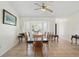 Bright dining room showcasing a glass table, bay window with shutter and neutral tiling at 10616 Ayear Rd, Port Charlotte, FL 33981