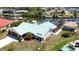 Beautiful waterfront home with lush landscaping, metal roof, and a spacious backyard at 10616 Ayear Rd, Port Charlotte, FL 33981