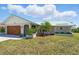 Charming home featuring an attached garage, arched front entry, and meticulous landscaping at 10616 Ayear Rd, Port Charlotte, FL 33981