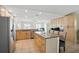 Open-concept kitchen featuring an island with seating and stainless steel appliances at 10616 Ayear Rd, Port Charlotte, FL 33981