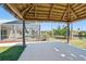 Waterfront tiki hut with a hammock and concrete floor next to the screened-in lanai at 10616 Ayear Rd, Port Charlotte, FL 33981