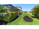 Lush backyard with a well-maintained lawn and tropical landscaping bordering the rear of the home at 11435 Apple Tree Cir, Bradenton, FL 34211