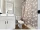 Well-lit bathroom featuring white vanity and patterned shower curtain at 11435 Apple Tree Cir, Bradenton, FL 34211