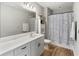 Stylish bathroom featuring a white vanity, a large mirror, and a shower with a black and white patterned curtain at 11435 Apple Tree Cir, Bradenton, FL 34211