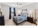 Serene bedroom featuring a metal frame bed, coordinated nightstands, and soft blue bedding for a relaxing ambiance at 11435 Apple Tree Cir, Bradenton, FL 34211