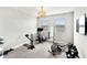 Bright bonus room equipped with exercise equipment, a mirror, and natural light to create an inviting workout space at 11435 Apple Tree Cir, Bradenton, FL 34211
