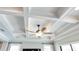 Close up of a coffered ceiling with modern fan and light, complemented by natural light from the adjacent windows at 11435 Apple Tree Cir, Bradenton, FL 34211