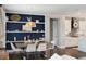 Dining room with decorative blue accent wall, modern table setting, and open access to the kitchen at 11435 Apple Tree Cir, Bradenton, FL 34211