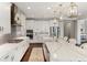 Bright, modern kitchen with white cabinets, stainless steel appliances, and a large center island at 11435 Apple Tree Cir, Bradenton, FL 34211