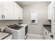Well-equipped laundry room featuring modern appliances, ample cabinetry, and a sleek countertop for folding at 11435 Apple Tree Cir, Bradenton, FL 34211
