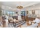Open-concept living room with a view of the pool and access to the kitchen at 11435 Apple Tree Cir, Bradenton, FL 34211