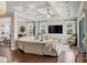 Open-concept living area with coffered ceilings, natural light, and seamless flow to the outdoor spaces at 11435 Apple Tree Cir, Bradenton, FL 34211