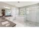 Stylish main bathroom with dual sinks, soaking tub, and glass shower at 11435 Apple Tree Cir, Bradenton, FL 34211