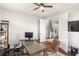 Well-lit office featuring a ceiling fan, modern desk, and direct access to the home's entryway and staircase at 11435 Apple Tree Cir, Bradenton, FL 34211